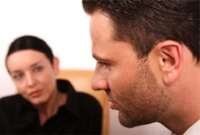 Female therapist listening to a male patient